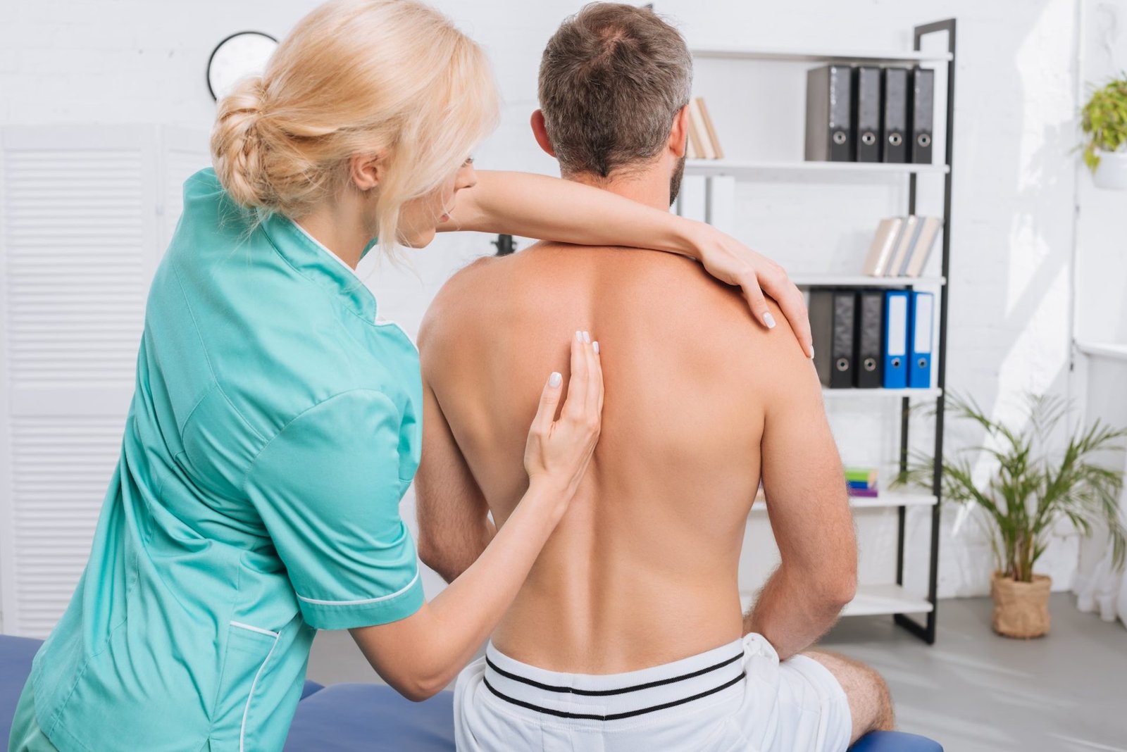 back-view-of-man-having-chiropractic-adjustment-in-clinic-e1683682730850.jpg